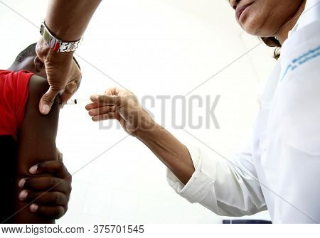 Salvador, Bahia / Brazil - September 21, 2017: Young Man Is Seen Receiving Yellow Fever Bill In Publ