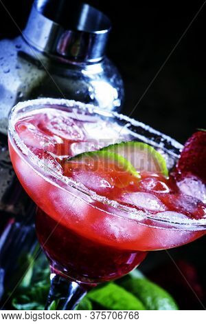 Alcoholic Cocktail With Strawberry, Lime And Ice, Black Background, Selective Focus