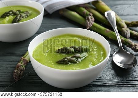 Delicious Asparagus Soup Served On Grey Wooden Table