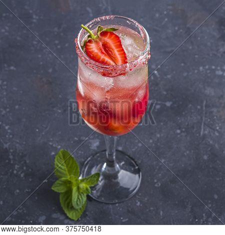 Cooling Rossini Italian Alcoholic Cocktail With Sparkling Wine, Strawberry, Ice Cubes In Champagne G