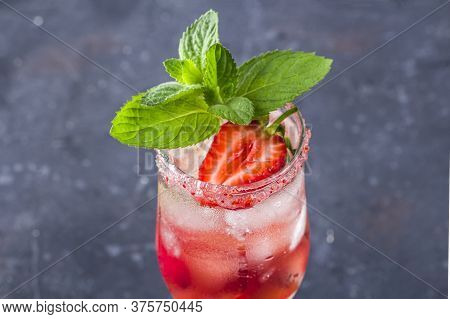 Cooling Rossini Italian Alcoholic Cocktail With Sparkling Wine, Strawberry, Ice Cubes In Champagne G