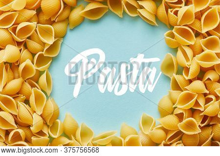 Round Frame Of Raw Conchiglie On Blue Background With Pasta Illustration