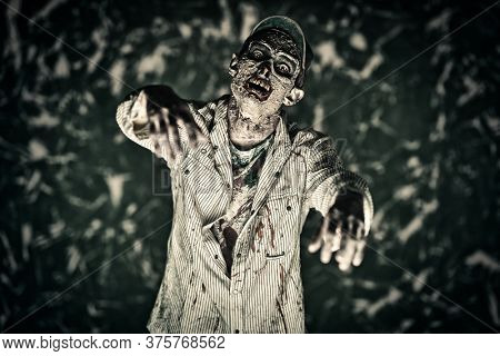 Scary bloodthirsty zombie man in a ruined building. Horror. Halloween.