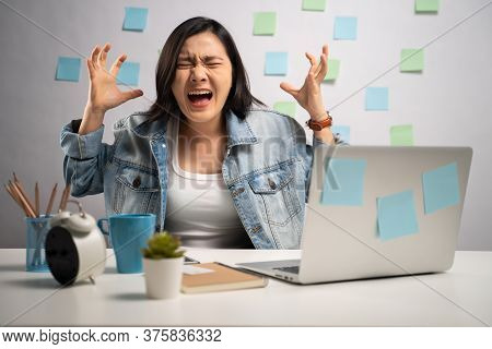 Asian Woman Angry Working On A Laptop And Shouting At Home Office. Wfh. Work From Home. Prevention C