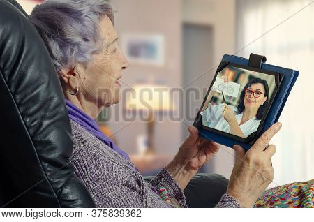 Telemedicine Female General Practitioner (gp) Explains To A Geriatric Patient The Importance Of Dete