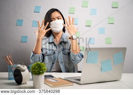 Don't Touch Your Face. Asian Woman Wearing Protective Face Mask Showing Hand Making Stop Sign At Hom