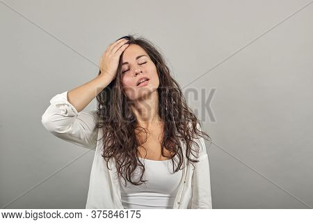 Stress Or A Headache Grimacing In Pain Holds The Back Of Neck Indicating Location. Fatigue During Wo