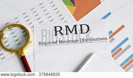 Paper With Required Minimum Distributions Rmd On A Table With Pen ,chart And Magnifier
