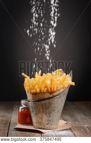 Pinch Of Salt Falling On French Fries
