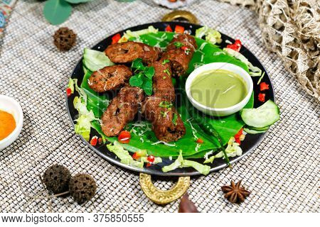 Traditional Asian Dish Named Kebab With Vegetable Sauce And Spices On A Served Table
Traditional Asi