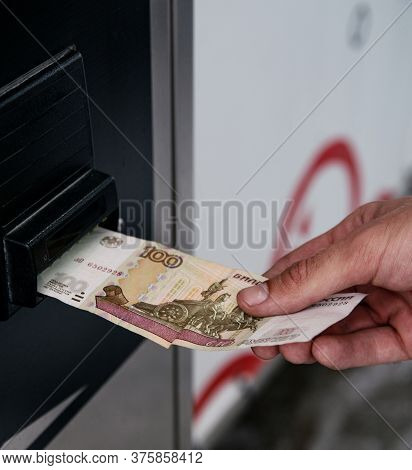 The Man’s Hand Pays 100 Rubles In A Machine With A Paper Russian Bill