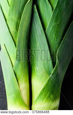 Organic Green Leek Onion On Black Textured Background, Top View.