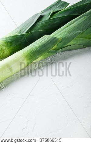 Organic Leek Onion Stalks On White Background, Side View, Selective Focus Space For Text.