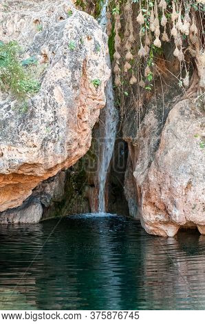 The Waterfall And Swimming Pool At The Ongongo Camping Site In The Kaokoveld Region Of Namibia. Bird