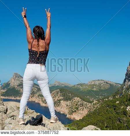 Portrait Of A Beautiful Young Hispanic Latina Woman, Doing Top Conquest Position, On The Mountain Cl