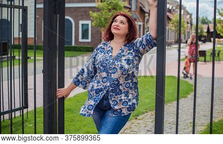 Mature Plus Size Woman, American Or European Appearance Walks And The  Enjoying Life. Lady With Exce