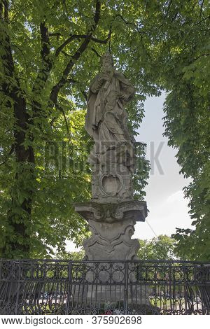 Old Statue Of St. Prokopa Standing On The Square In Front Of The Sanctuary Of The Blessed Virgin Mar