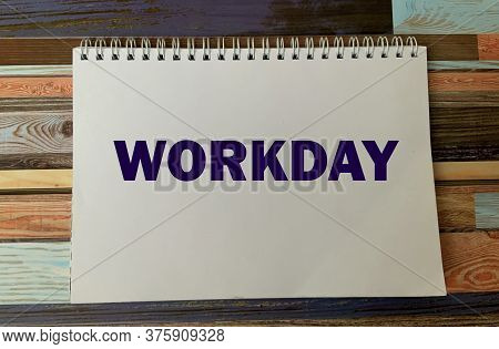 Workday On A White Notepad On A Wooden Background