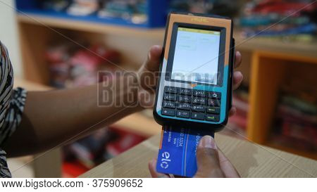 Salvador, Bahia / Brazil - November 22, 2019: Person Uses Credit Card Machine In Shoppng Shop In The