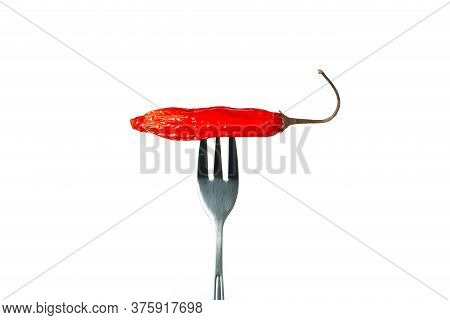 Hot Chili Pepper Pricked On A Fork Isolated On White Background.