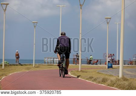 Salvador, Bahia / Brazil - October 13, 2019: Cyclist Is Seen Riding A Bicycle Along The Bike Path Ne