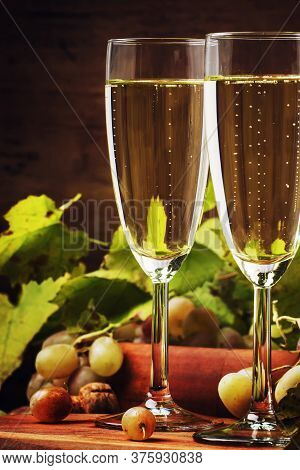 Champagne In Glasses, Grapes With Vine, Vintage Wood Background, Selective Focus