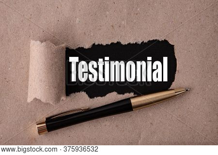 Testimonial Text Written Under Torn Paper And A Recumbent Metal Pen. Business Strategy Concepts.