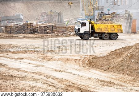 Multi-ton Heavy Mining Dump Truck Loaded During Removal Of Construction Soil From Construction Site.