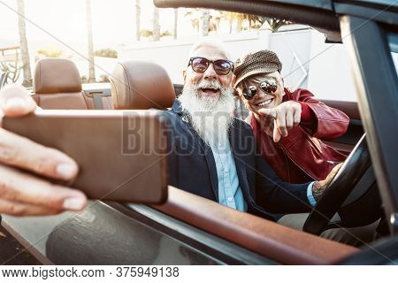 Happy Senior Couple Taking Selfie On New Convertible Car - Mature People Having Fun In Cabriolet Tog