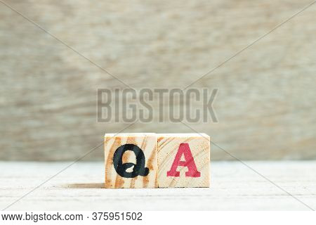 Alphabet Letter In Word Qa (abbreviation Of Quality Assurance Or Question And Answer) On Wood Backgr
