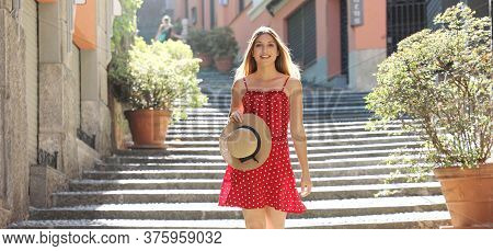 Happy Travel Tourist Woman Going Downstairs In Bellagio On Lake Como, Italy. Girl On Summer Vacation