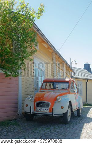 Porvoo, Finland - 3 June 2020: Beautiful Street With Blooming White Lilac And Vintage Car Citroen 2C