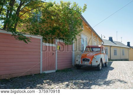 Porvoo, Finland - 3 June 2020: Beautiful Street With Blooming White Lilac And Vintage Car Citroen 2c