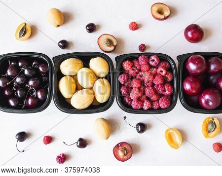 Fresh Berries Are Packed In Trays. Vitamin-rich Fruits Are Packaged In Boxes. Variety Of Fruits For 