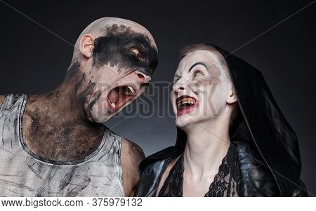 Photo Of Mad Screaming Man And Scary Woman With Blood Hands