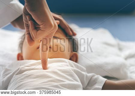 The Doctor Is Using Two Fingers To Press Down In The Middle Of The Baby's Chest, Which Is Cpr In The