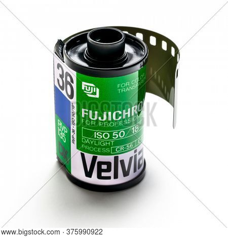 Fort Collins, CO, USA - July 11, 2020: A roll of 35mm Fujichrome Velvia fim on white. This very saturated color slide film used to be popular among nature and landscape photographers.