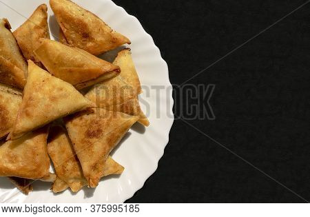 Famous Traditional Arabic, Middle East, Asian Cuisine. Triangular Arabic Chicken Samosa On Dark Blac