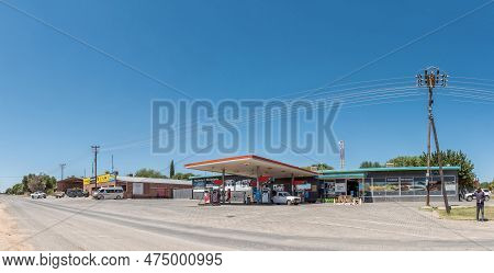 Douglas, South Africa - Mar 1, 2023: A Street Scene, With A Gas Station, Tyre Workshop, People And V