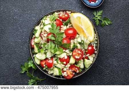 Bulgur Tabbouleh Salad With Red Cherry Tomatoes, Cucumbers, Parsley And Lemon Dressing. Traditional 