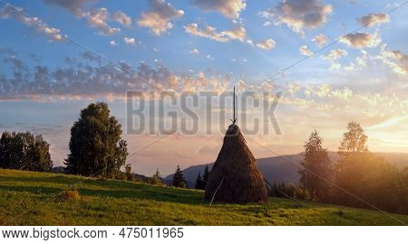 Sunset On Summer Mountainous Green Meadow With Stack Of Hay (slavske Village, Carpathian Mts, Ukrain