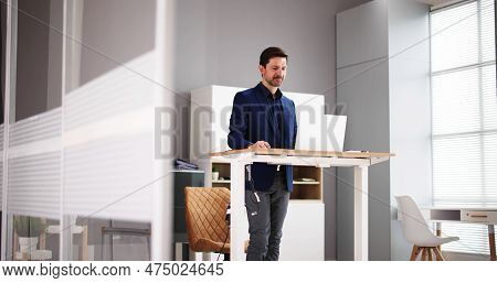 Adjustable Height Desk Stand In Office Using Computer