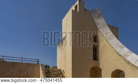 A Fragment Of The World's Largest Ancient Sundial. The Base Is Made Of Orange Sandstone, The Curved 