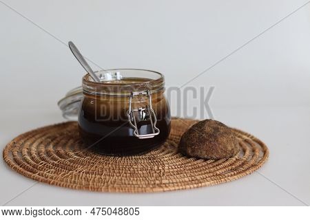 Homemade Palm Jaggery Syrup. Liquid Palm Jaggery Made By Heating Block Of Solid Palm Jaggery. Health