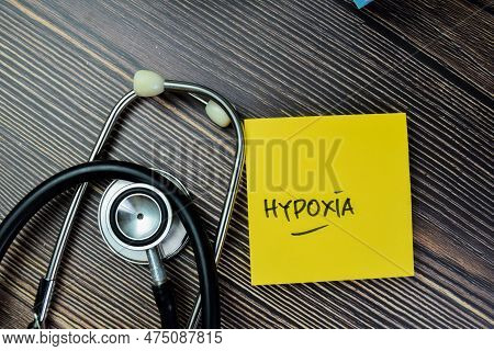 Concept Of Hypoxia Write On Sticky Notes With Stethoscope Isolated On Wooden Table.