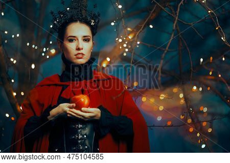 Evil Queen Holding A Red Poisonous Apple As Bait \nfantasy Fairy Tale Villain Planning A Witchcraft 
