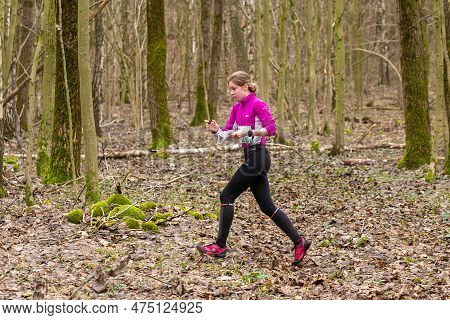 Strong Caucasian Teenage Girl Wearing Sportswear Running Through A Forest
