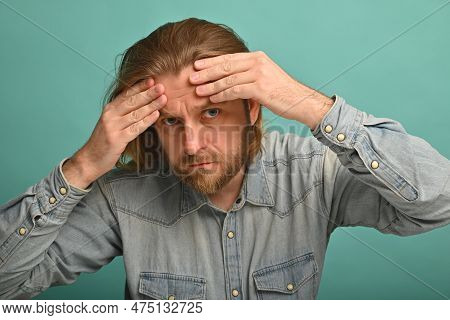 Man In Front Of Mirrror Looking At His Wrinkles