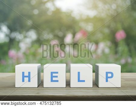 Help Letter On White Block Cubes On Wooden Table Over Blur Pink Flower And Tree In Garden, Business 