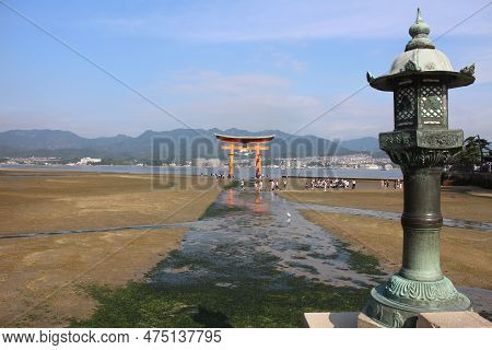 Seaweed Path To Itsukushima Shrine's Torii In Miyajima Island, Hiroshima, Japan